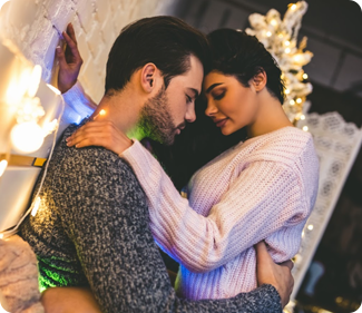couple getting intimate to show that tingling and cooling sensations enhance your sexual experience, both in sweaters with twinkle lights to show cooling lube imagery