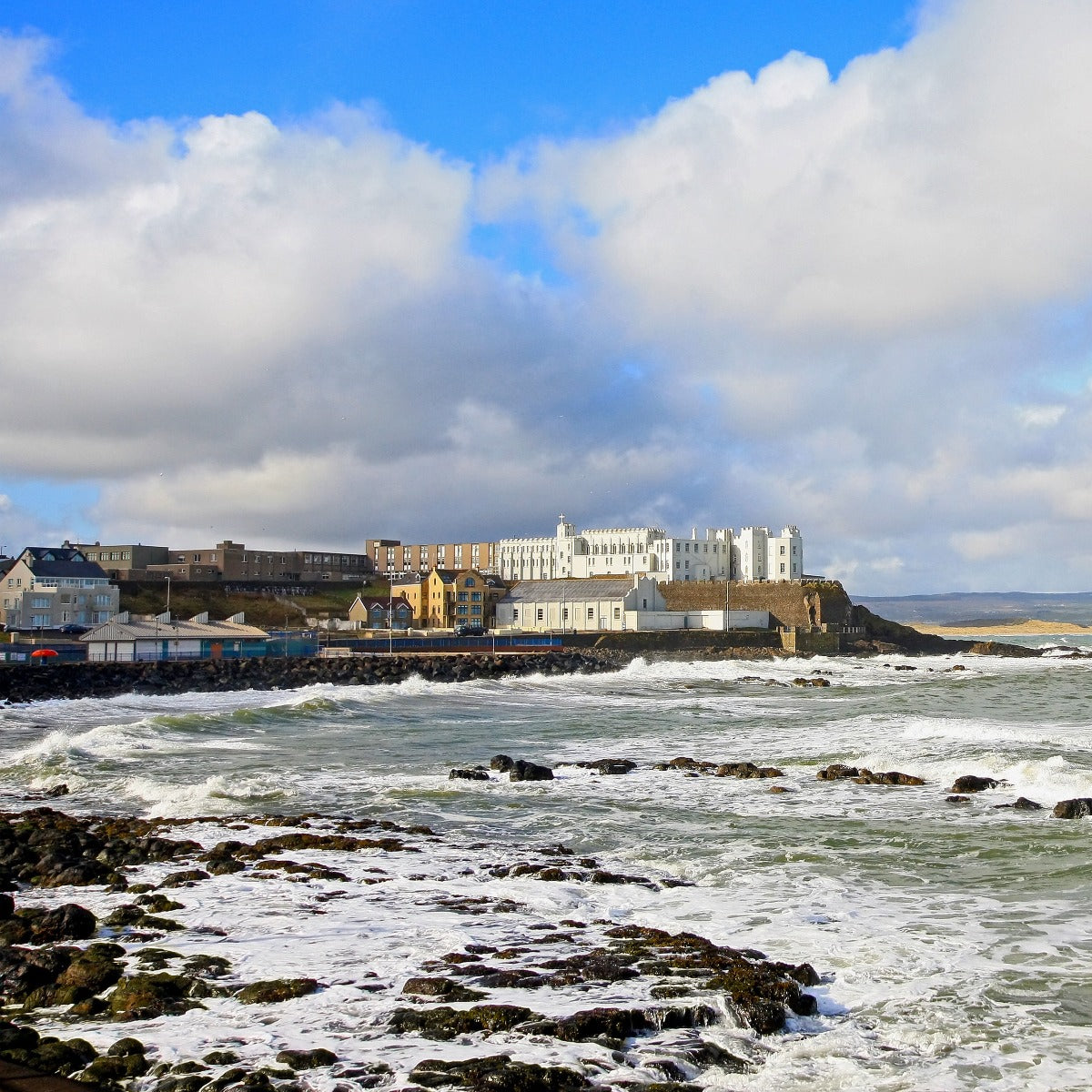 Looking at the Dominican College, Portstewart, over stormy seas, taken from the Promenade