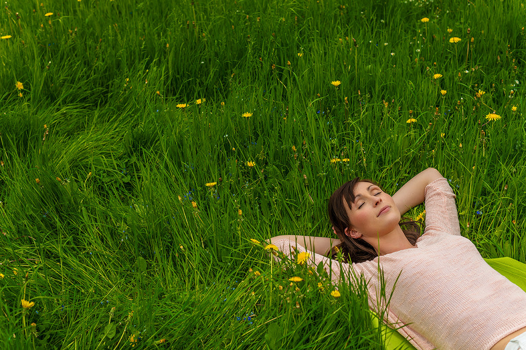 Woman lying down on the grass