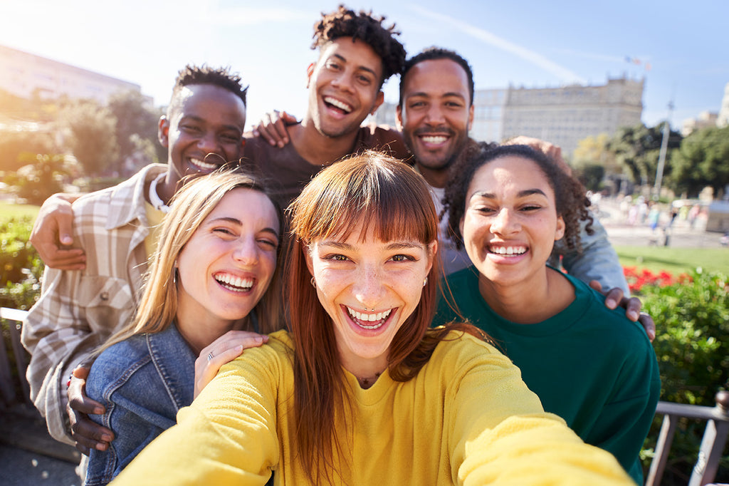 group of friends smiling under the sunshine