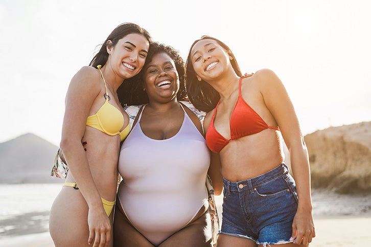 multiracial group of female friends on the beach