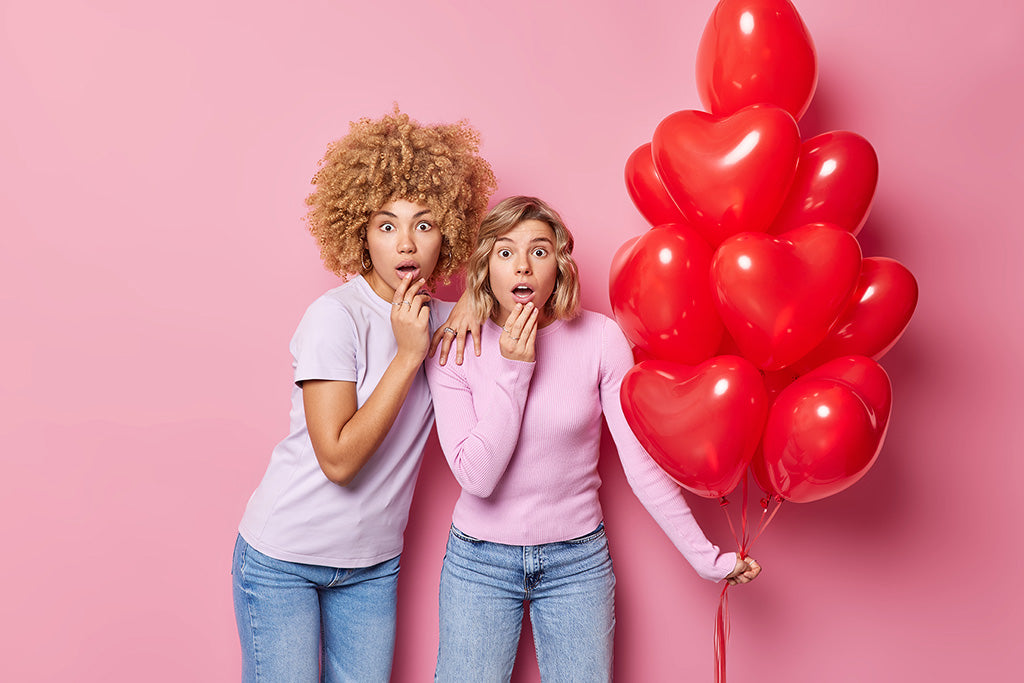 two women surprised with heart balloons valetines