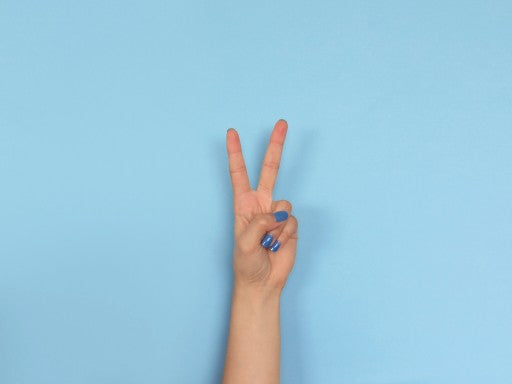 hand peace sign on blue background