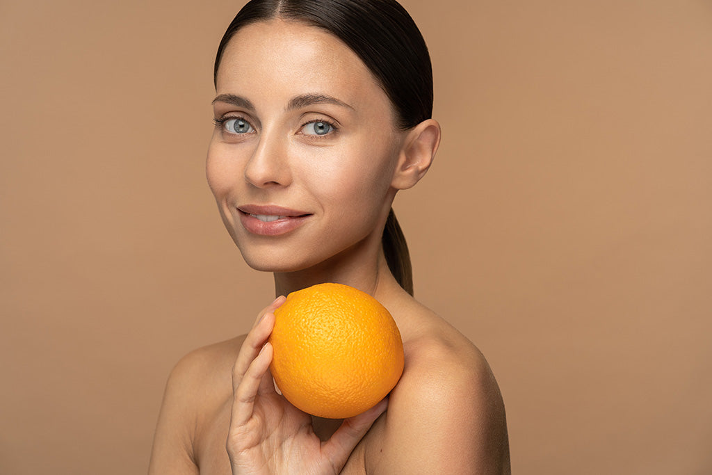 woman holding citrus fruit