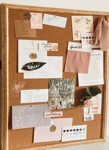 cork board with images of wedding accessories