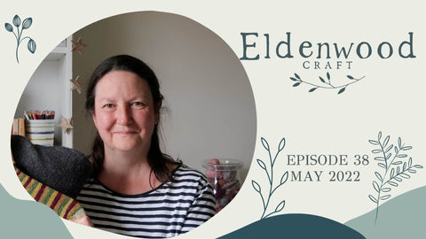 Cover shot of the Eldenwood Craft knitting podcast. Emma holds her finished objects to show.