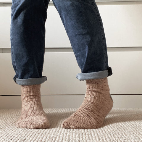 A pair of pink hand knit socks 