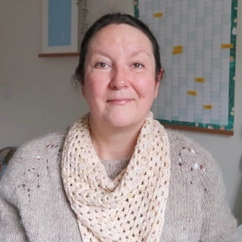 Emma, the host of the Eldenwood Craft knitting podcast, wears her newly finished crochet granny cowl. 