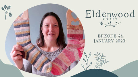 A cover shot from the Eldenwood Craft knitting podcast showing Emma holding up two pairs of finished hand knit socks.