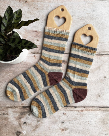 Handknit socks in a striped yarn in colours blue and yellow