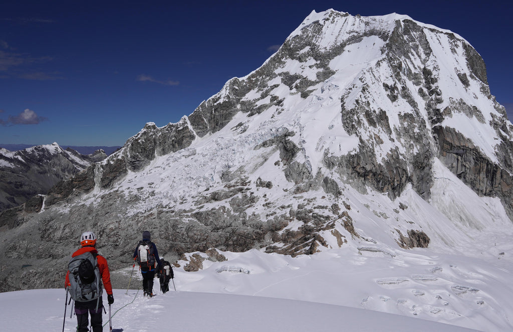 Climbers descending Ishinca peak on the Southeast Slopes in The Cordillera Blanca in Peru