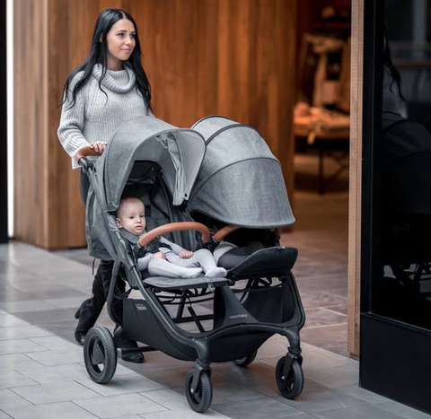 best strollers for twins and multiples - woman pushes babies in valco baby snap duo trend stroller