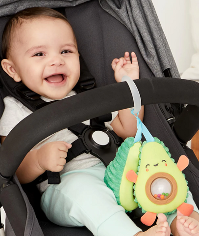 baby plays with avocado car seat toy