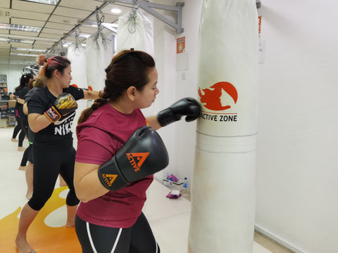 kickboxing women punching boxing bag