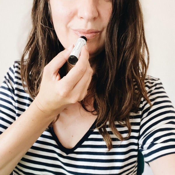 woman applying etta and billie lip balm