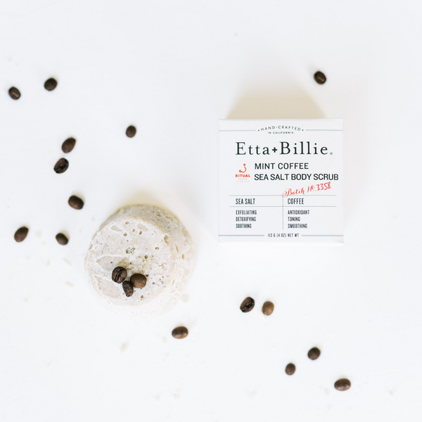 etta and billie body scrub bar on counter with fresh coffee beans