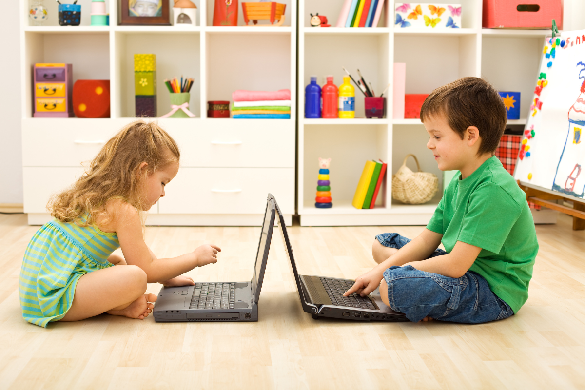 Two small children learning on a computer