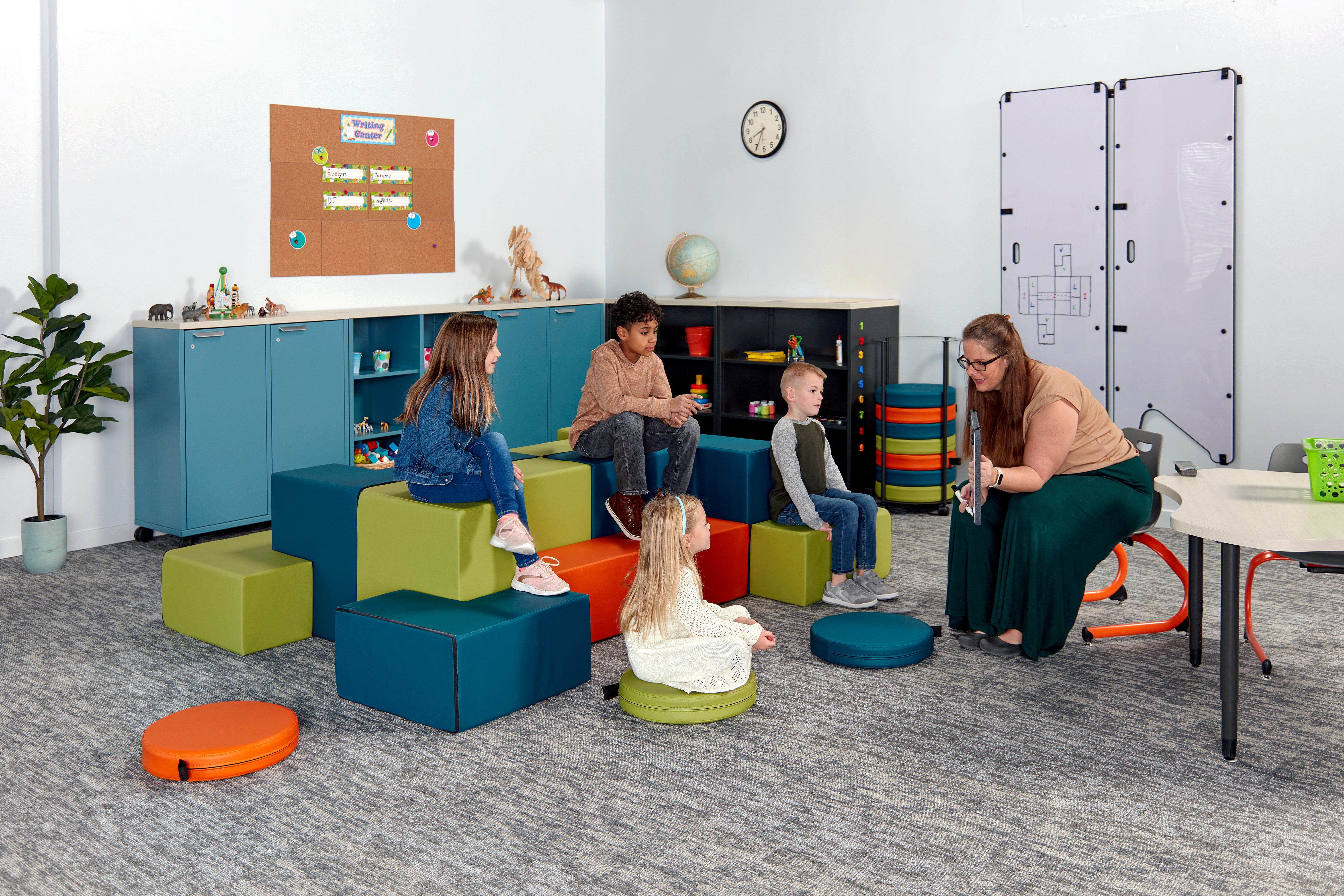 Kids sitting on modular seating system while focusing on the teacher