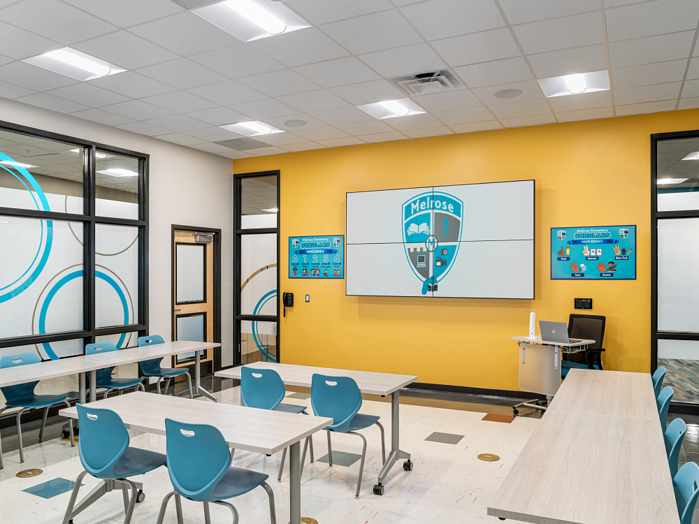 Classroom with a customized looking room with the bran of the school 