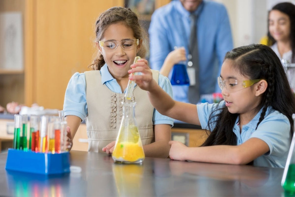 Excited schoolgirls perform chemistry experiment