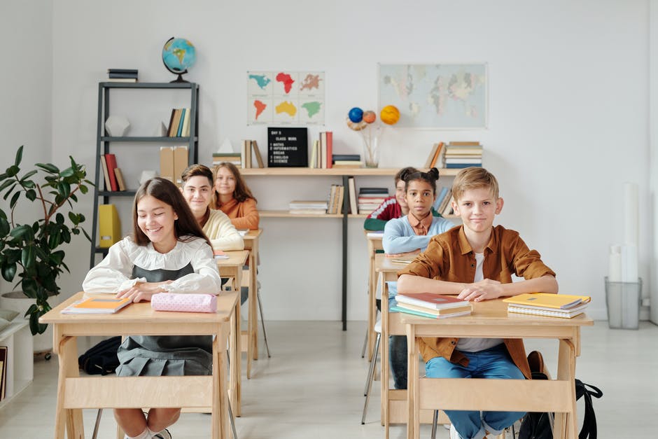 Children sitting in a classroom smiling