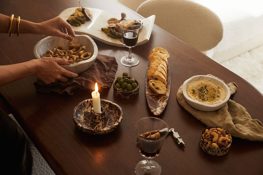 A tablescape features the Marble Bowl and Marble Candle Holder by Chloé Crane-Leroux x Anastasio Home.