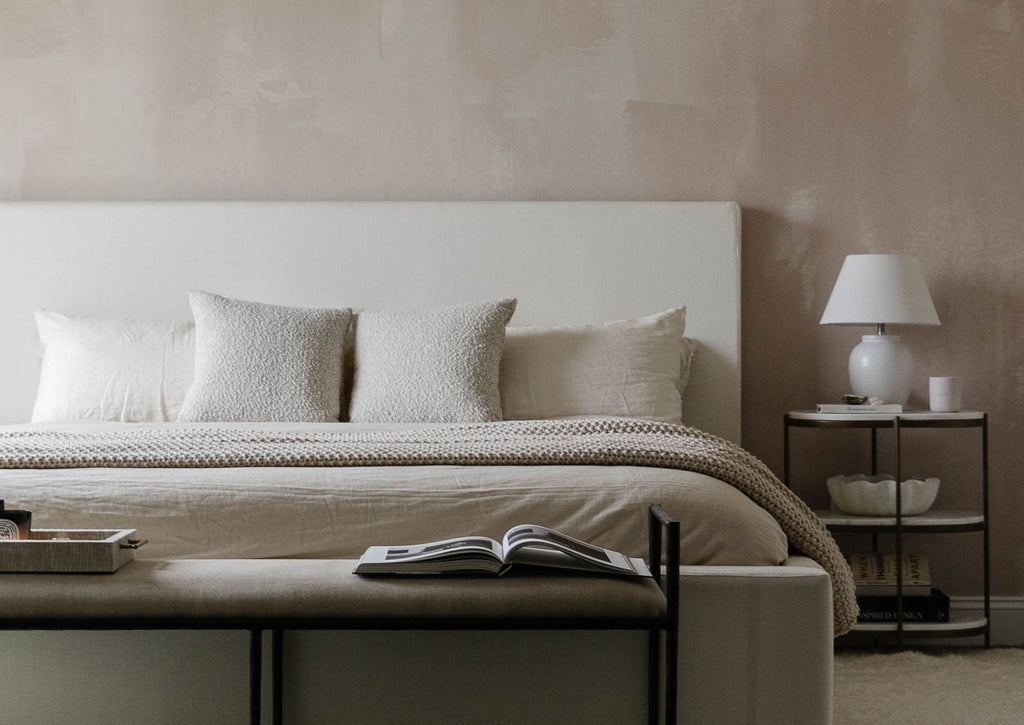 Chriselle Lim's bedroom includes the upholstered Lockwood Bed, marble and iron rounded Kayleigh Nightstand, and Arteriors Barbana Bench with iron frame and upholstered seat.