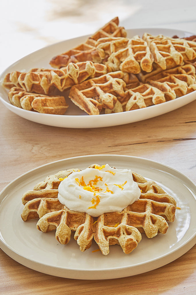 Brown butter homemade waffles sit on round white plates from Casafina.