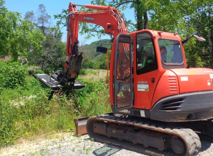 Kubota excavator with a brush cutter