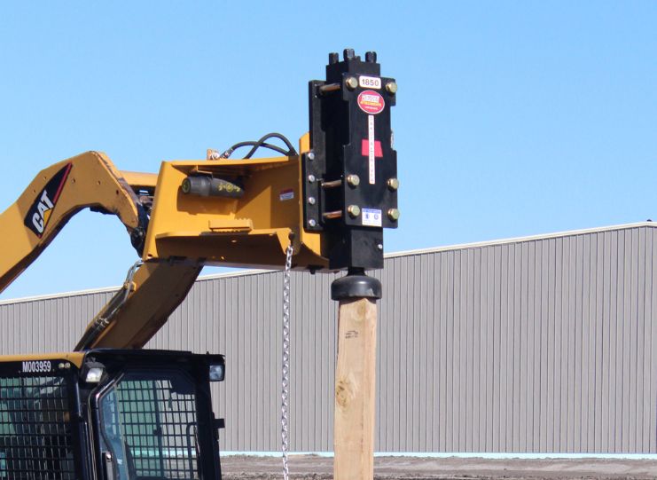 Dakota post driver on a Cat skid steer