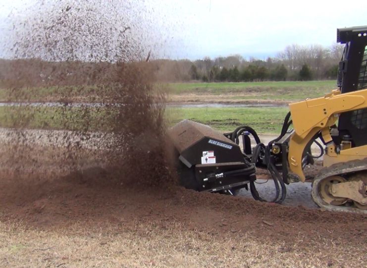 angle broom attachment on cat skid steer