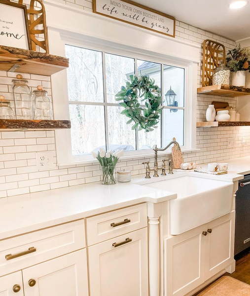 Modern farmhouse kitchen all in white with brushed antique brass cabinet hardware.