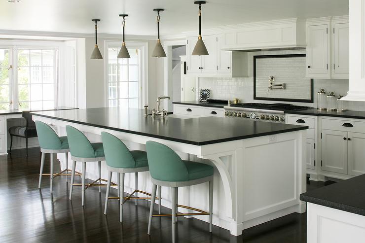 Large kitchen featuring white cabinets and black nickel cabinet handles. 