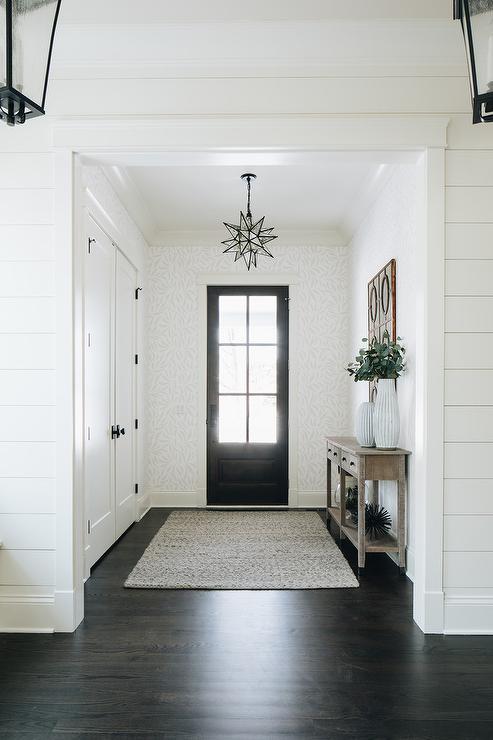 Front hall closet with black passage knobs
