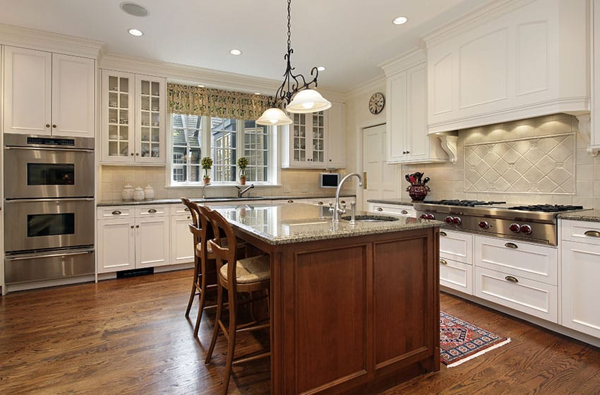 Traditional kitchen with wood floors and graphite cabinet hardware on the cabinets.