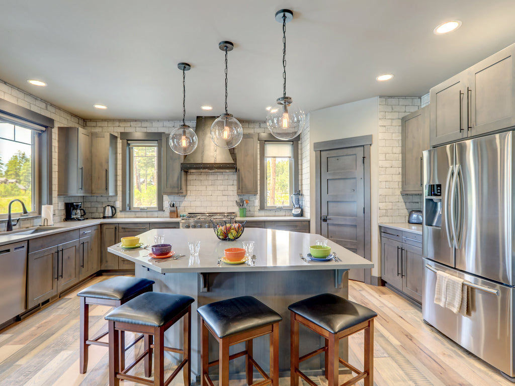 This modern kitchen has large black Euro bar pulls on various sized cabinet doors. The look is a stylish way to add balance to the cabinetry.