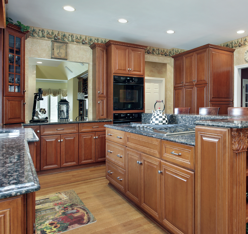 traditional kitchen with brown mahogany cabinets and satin nickel pulls and knobs