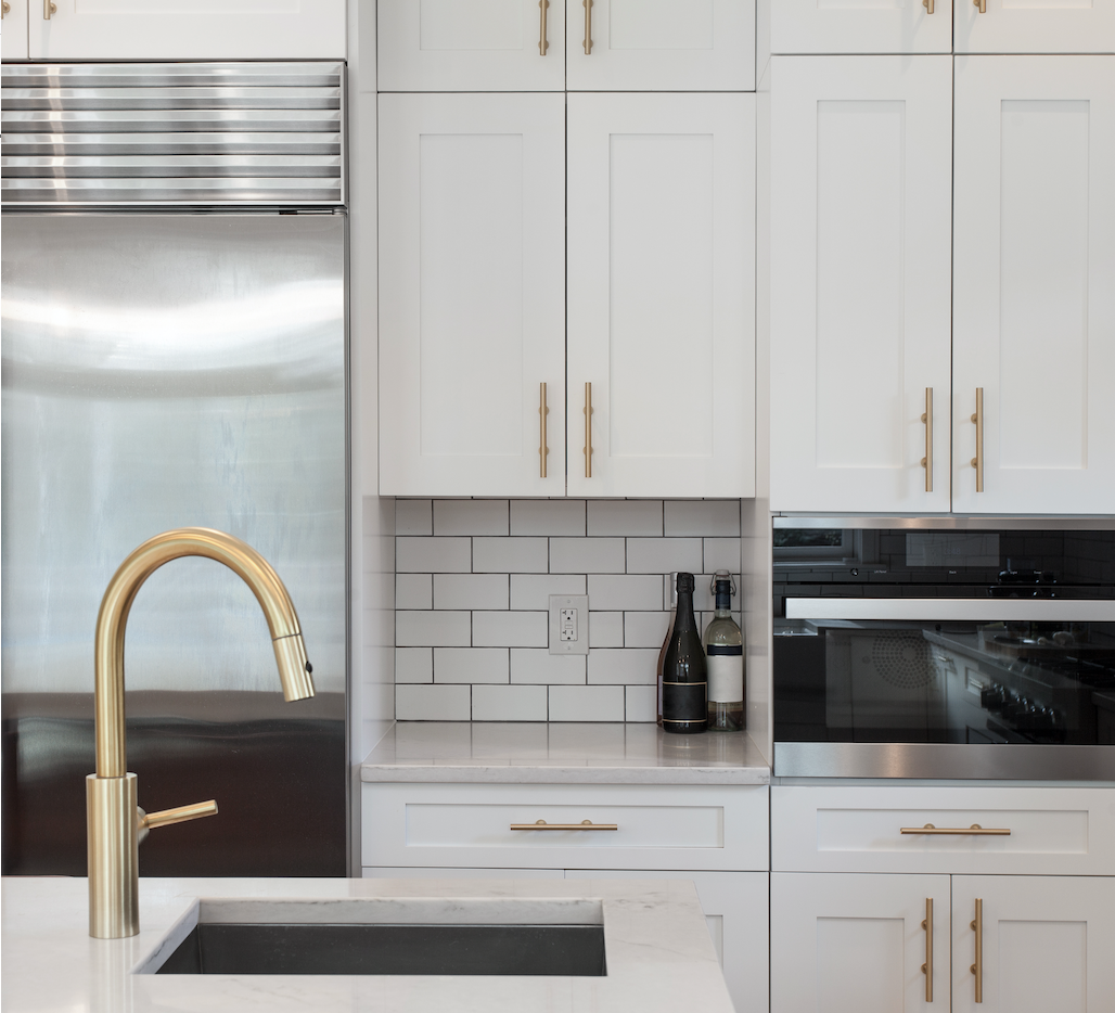White kitchen with Gold bar pulls on the white kitchen cabinets