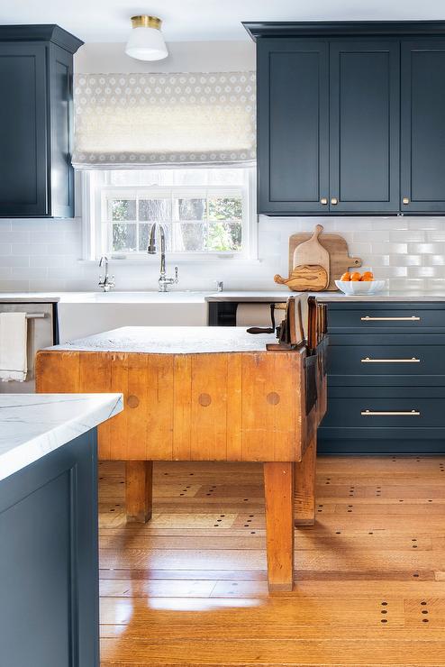 farmhouse kitchen with blue cabinets and satin nickel cabinet pulls and knobs