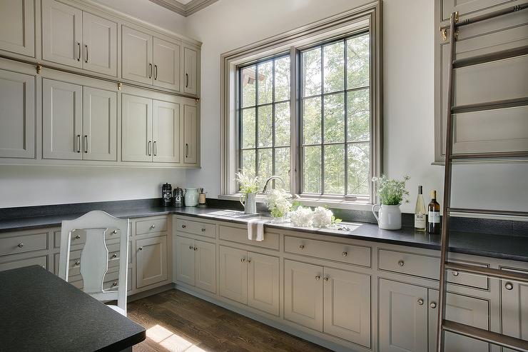 Greige kitchen cabinets in a french country pantry kitchen with satin nickel pulls by Diversa  1068-96-BSN