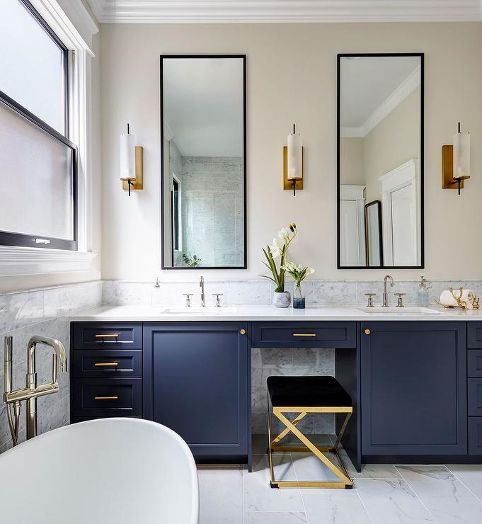 Kitchen with blue vanity and brushed brass knobs and brushed brass Euro pulls on the drawers and pulls. 