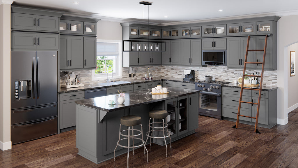 Kitchen with large gray shaker cabinets and with black cabinet knobs and black drawer pulls. 