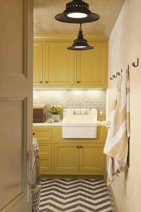 Yellow laundry room with wall hooks