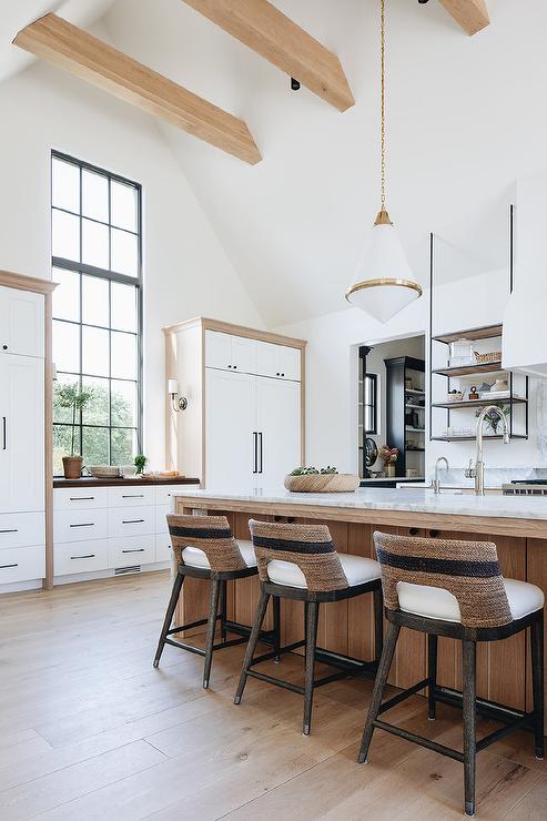 These cabinet pantries have cabinet pulls over 17 inches long and look fabulous in this stunning kitchen with expansive ceilings and wood accents. 