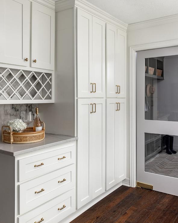 This bank of tall pantry storage cabinet doors feature a pair of smaller pulls measuring approximately 5 inches overall.  