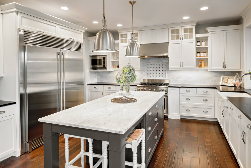 silver cup pulls and standard cabinet pull in white kitchen 