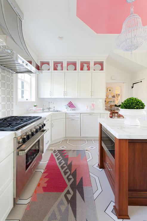 The above colorful kitchen showcases how cabinet doors have different pull placement, both horizontal and vertical, depending on the function and location of the door. 