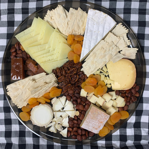 Cheese platter including five cheeses, apricots, marcona almonds, caramelized pecans, and crackers