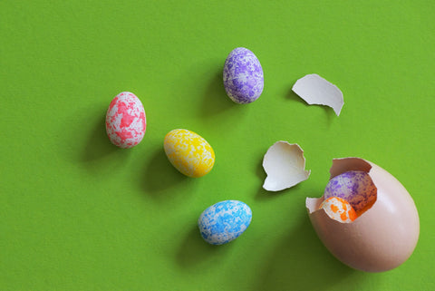 chocolate easter eggs spill out of cracked egg