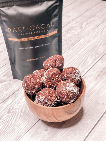 bare bare balls, cacao bowls in a wooden ball next to packet of bare cacao